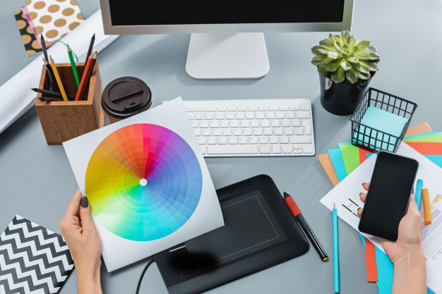 gray-desk-with-laptop-notepad-with-blank-sheet-pot-flower-stylus-tablet-retouching_155003-2431